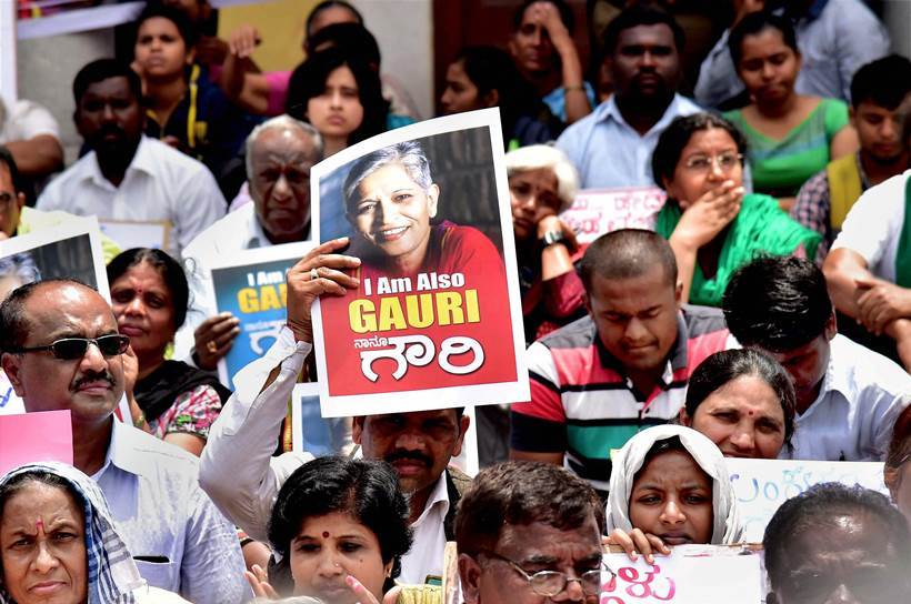 Bengaluru: Citizens with posters and placards during a protest against the killing of journalist Gauri Lankesh, who was shot dead by motorcycle-borne assailants outside her residence last night, during a protest in Bengaluru on Wednesday. PTI Photo by Shailendra Bhojak (PTI9_6_2017_000034A)